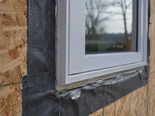 A window with a nailing fin set into a framed opening in bare sheathing
